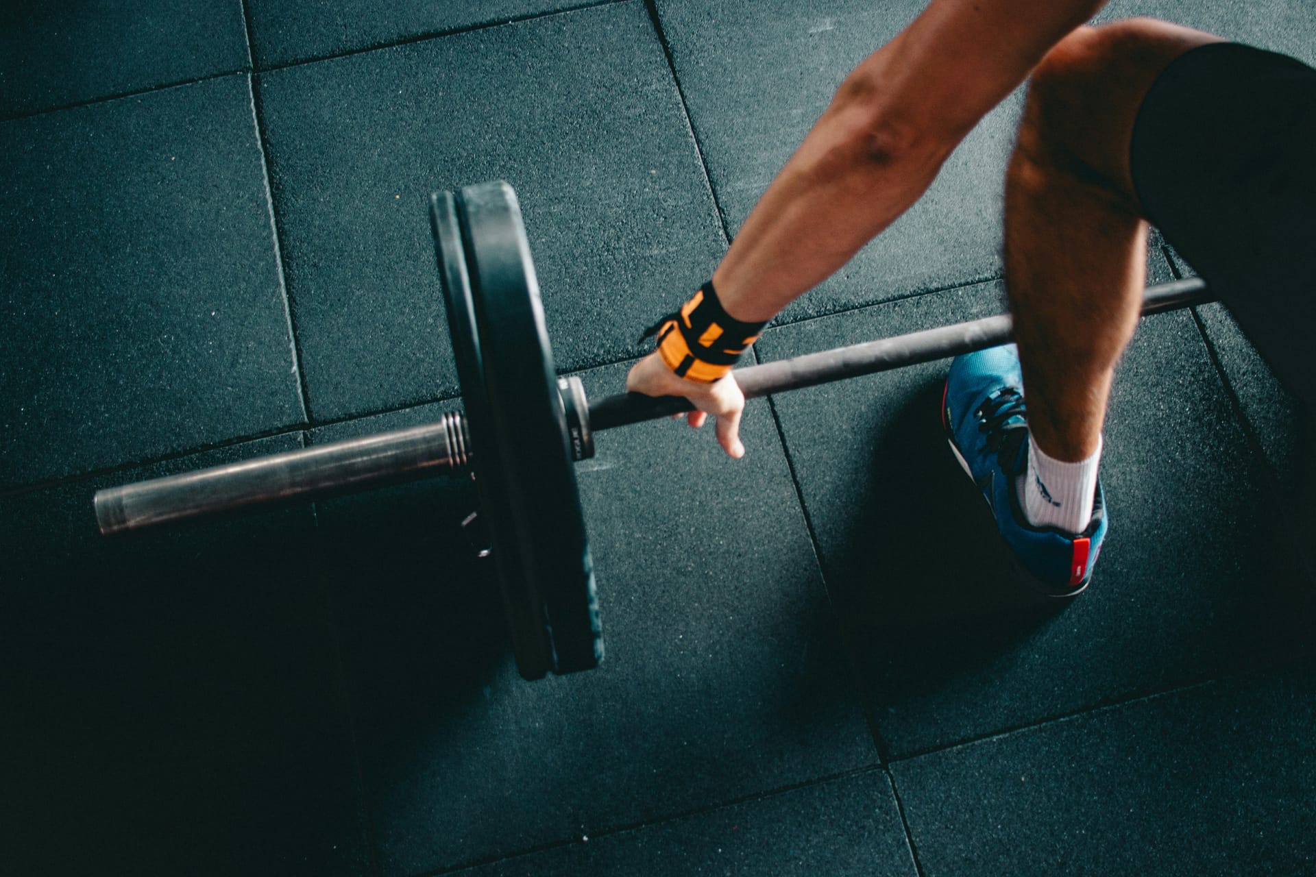 Person training with barbell in gym
